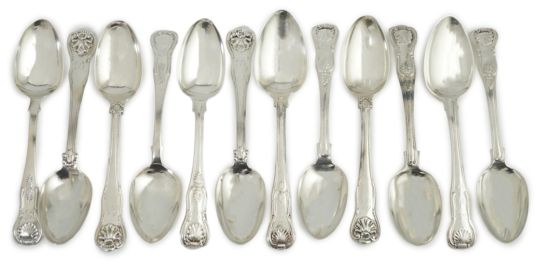 A harlequin set of twelve Georgian and Victorian silver Kings pattern dessert spoons, various dates and makers